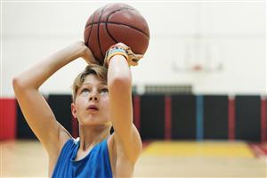 Young Boy Shooting For The Hoop